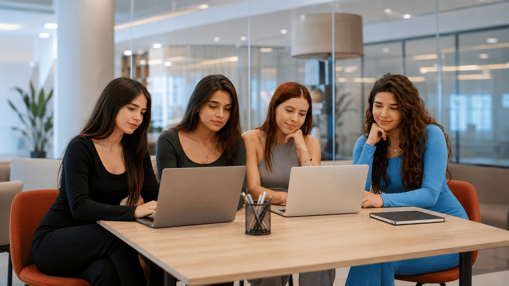 Analysts reviewing live reporting dashboards together on their laptops